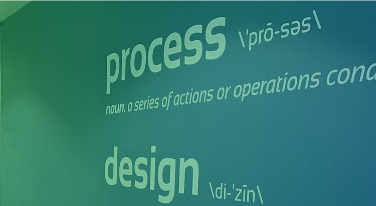 Wall text defining the words "process" and "design" with phonetic spelling
